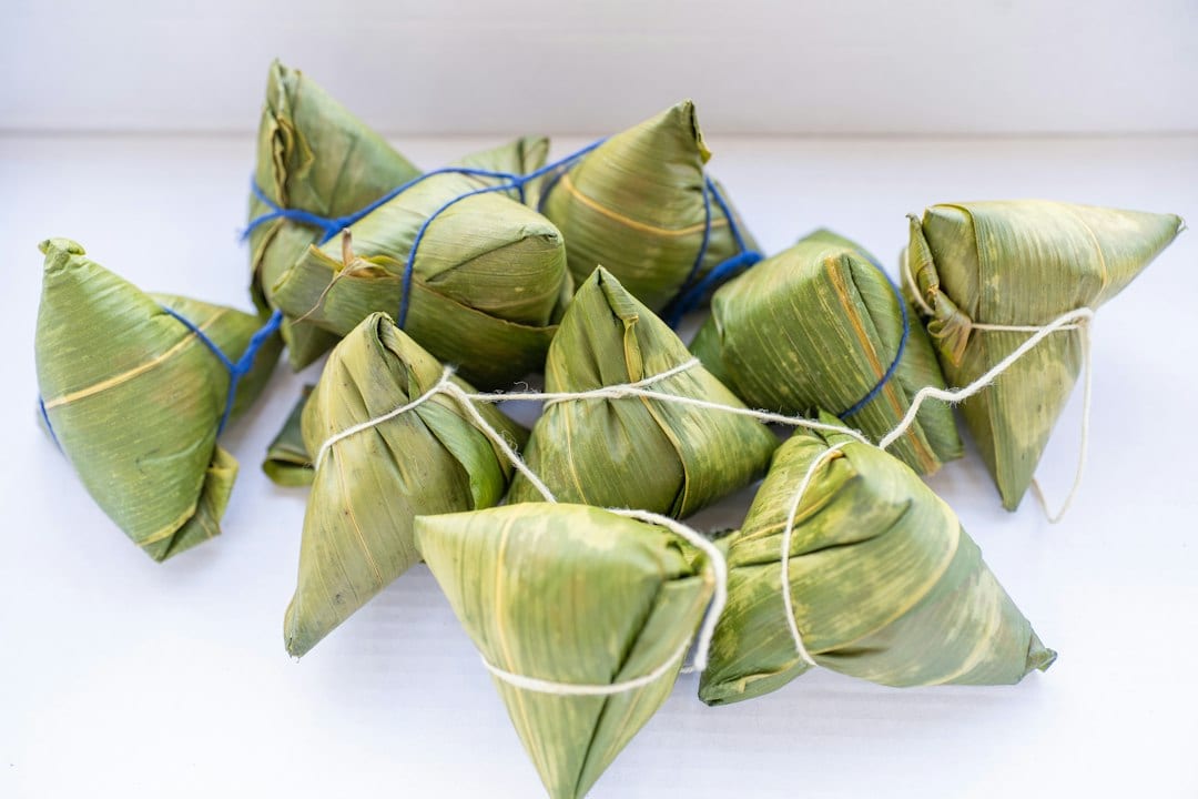 Glutinous rice dumplings wrapped in green leaves