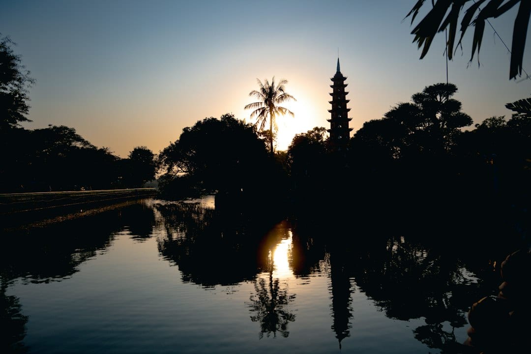 Chinese pagoda at sunrise with garden reflection