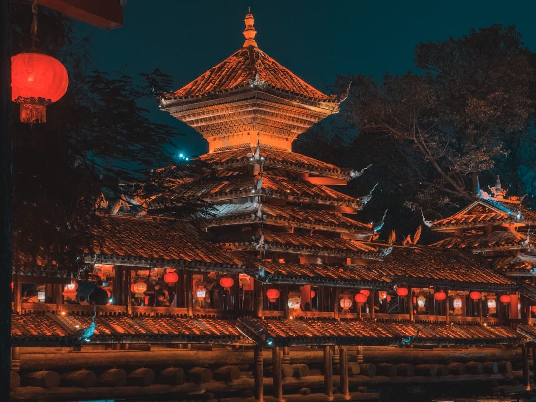 Snow village at night with warm glowing red lanterns