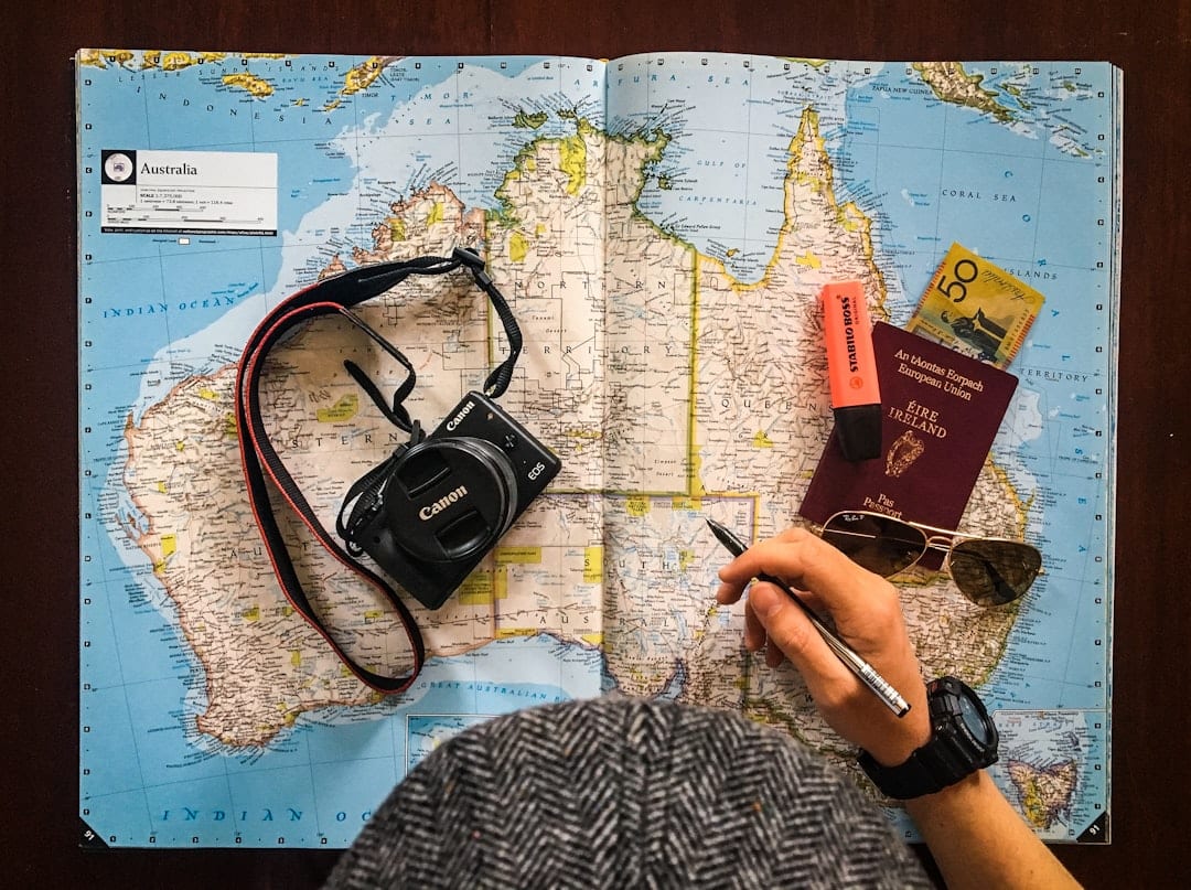 Travel planning consultation with map and laptop